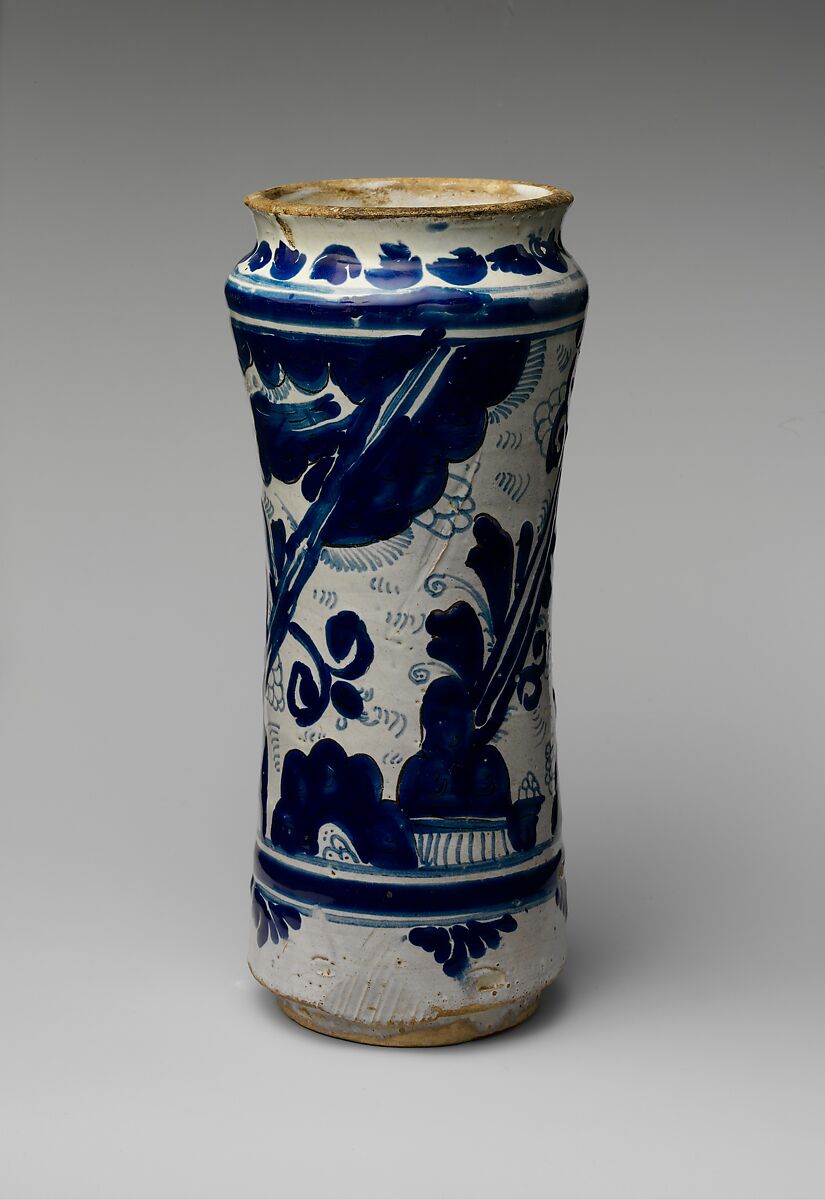 Earthware apothecary jar in blue and white, patterned with a floral design