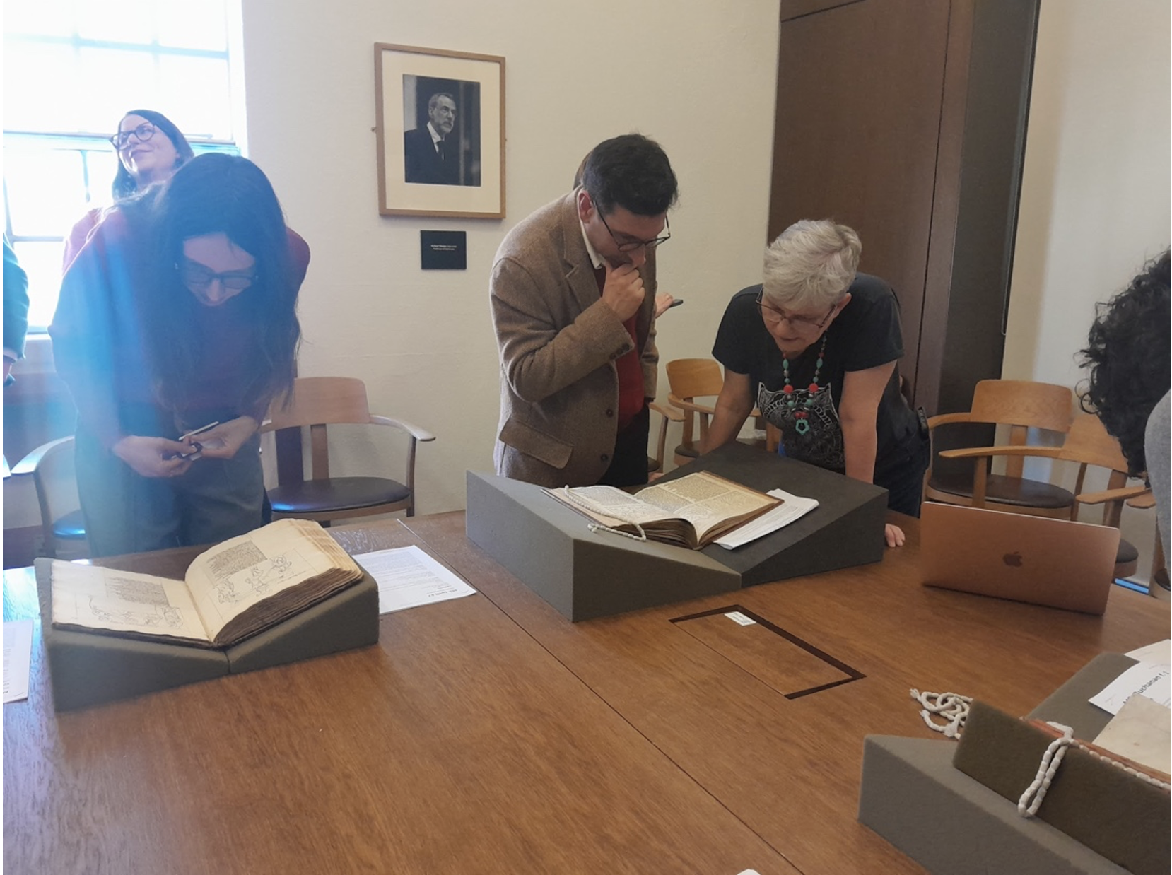 Participants looking at manuscripts in the Weston Library