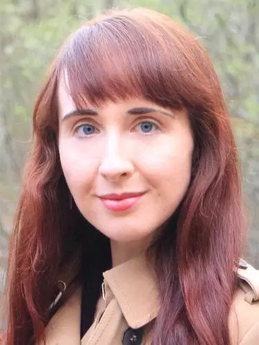 Photo of Amy Lidster, outside, smiling to camera.