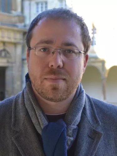 Photo of Joe Moshenska outside looking to camera. 