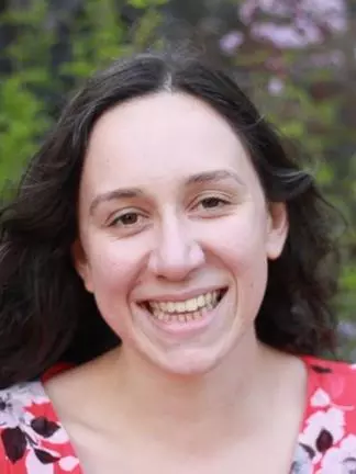 Photo of Sadie Jarrett, outside, smiling to camera. 