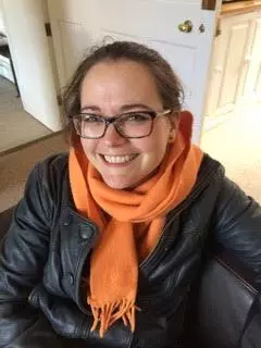 Photo of Sophie Nicholls looking upwards to camera, smiling. 