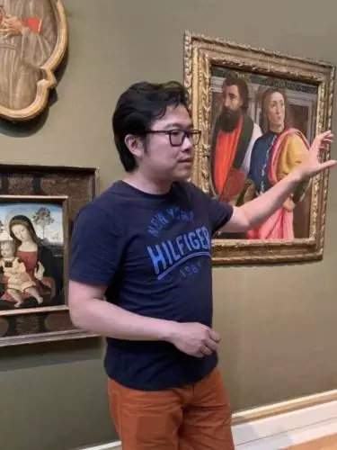 Ang Li Standing in Art Gallery.
