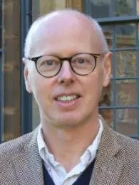 Photo of Michael Hawcroft smiling to camera.