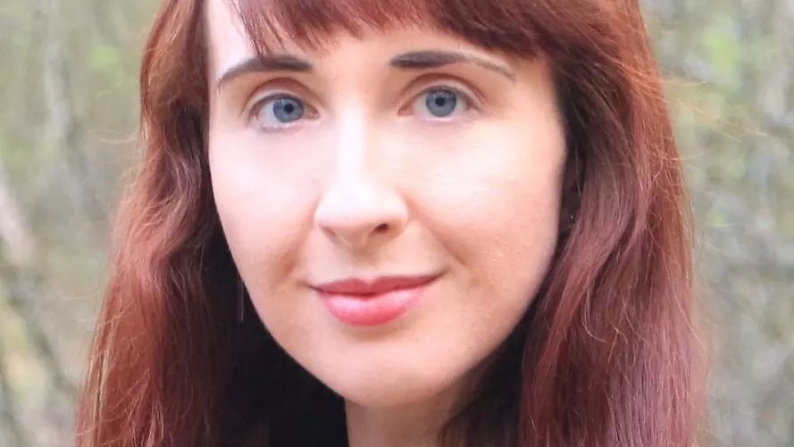 Photo of Amy Lidster, outside, smiling to camera.