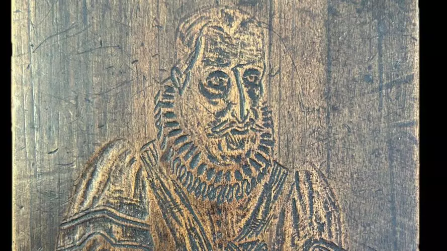 Roughly engraved on wood, a figure of a man