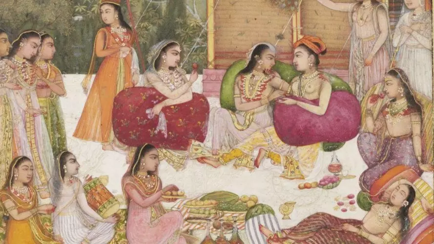 The painting, in opaque watercolour and gold on paper, shows a group of ladies and their female attendants at leisure under an orange awning fixed to a pavilion on a terrace within a garden setting with trees in the background and grass in front.