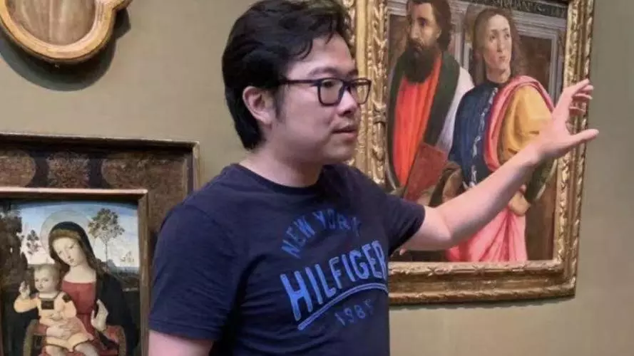 Ang Li Standing in Art Gallery.