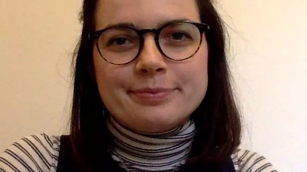 Photo of Annalisa Nicholson smiling to camera in front of a white background.