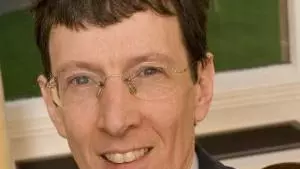 Photo of Colin Burrow smiling to camera.