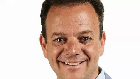 Photo of Filippo de Vivo in front of a white background smiling to camera