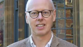 Photo of Michael Hawcroft smiling to camera.