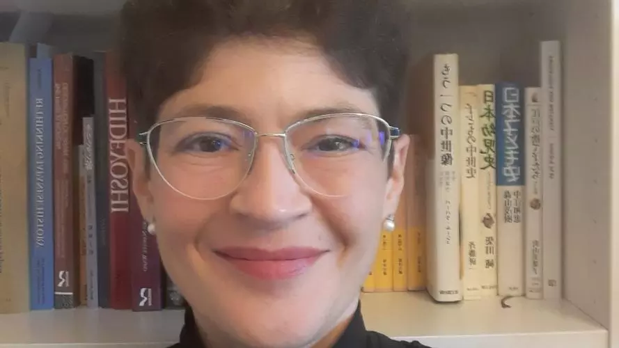 Dr. Pia Jolliffe against a background of books